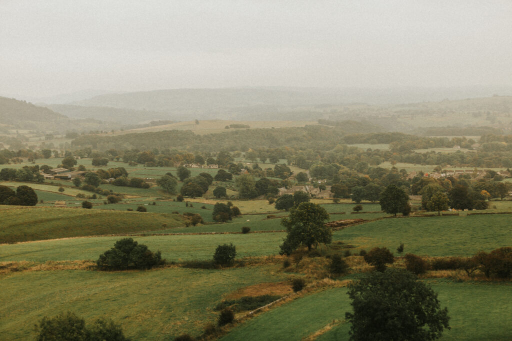 Ascenic Peak District landscape in the background, moments after a surprise proposal. Perfect natural setting for romantic engagement photography.