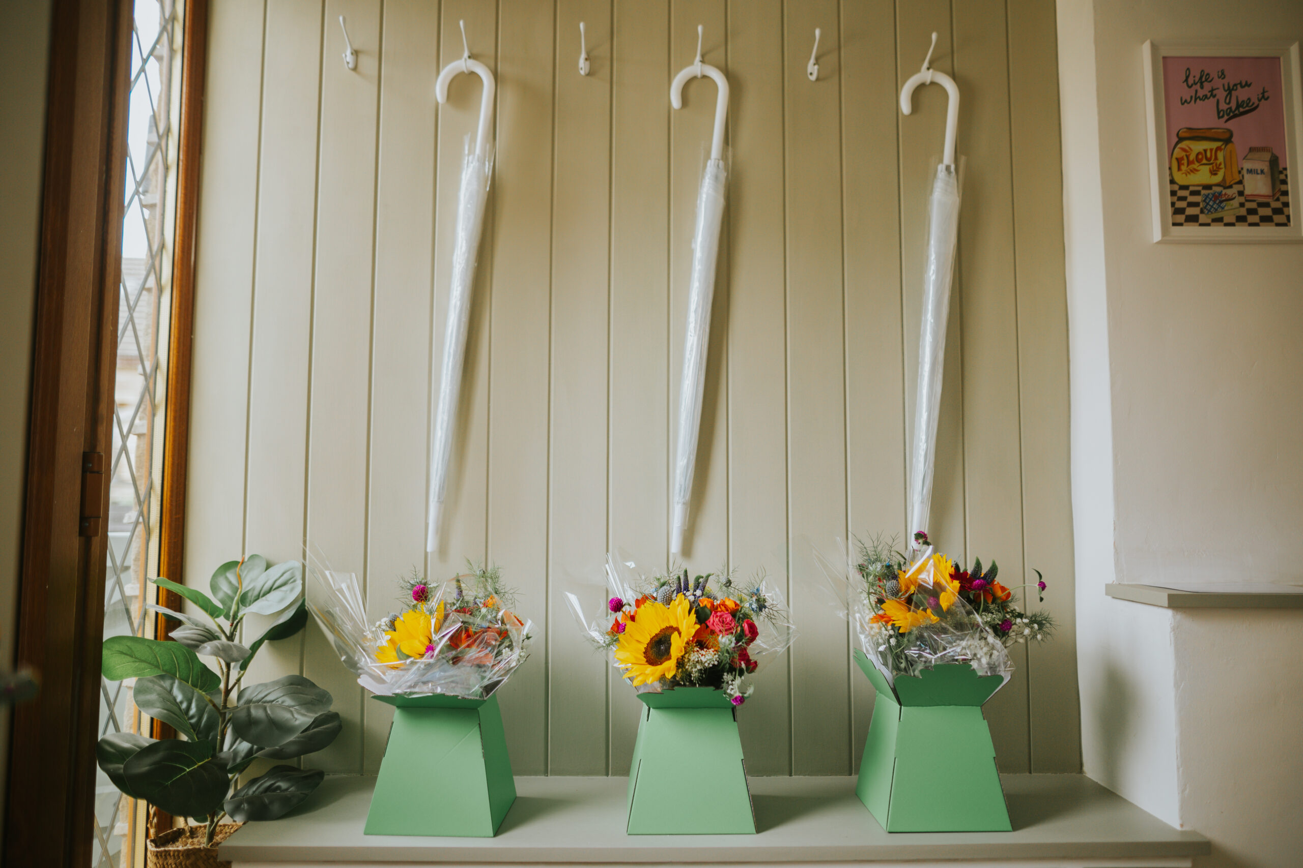 Umbrellas and vibrant flower arrangements at a back garden wedding, showcasing thoughtful details and unique wedding ideas for guests to enjoy a perfect outdoor celebration.