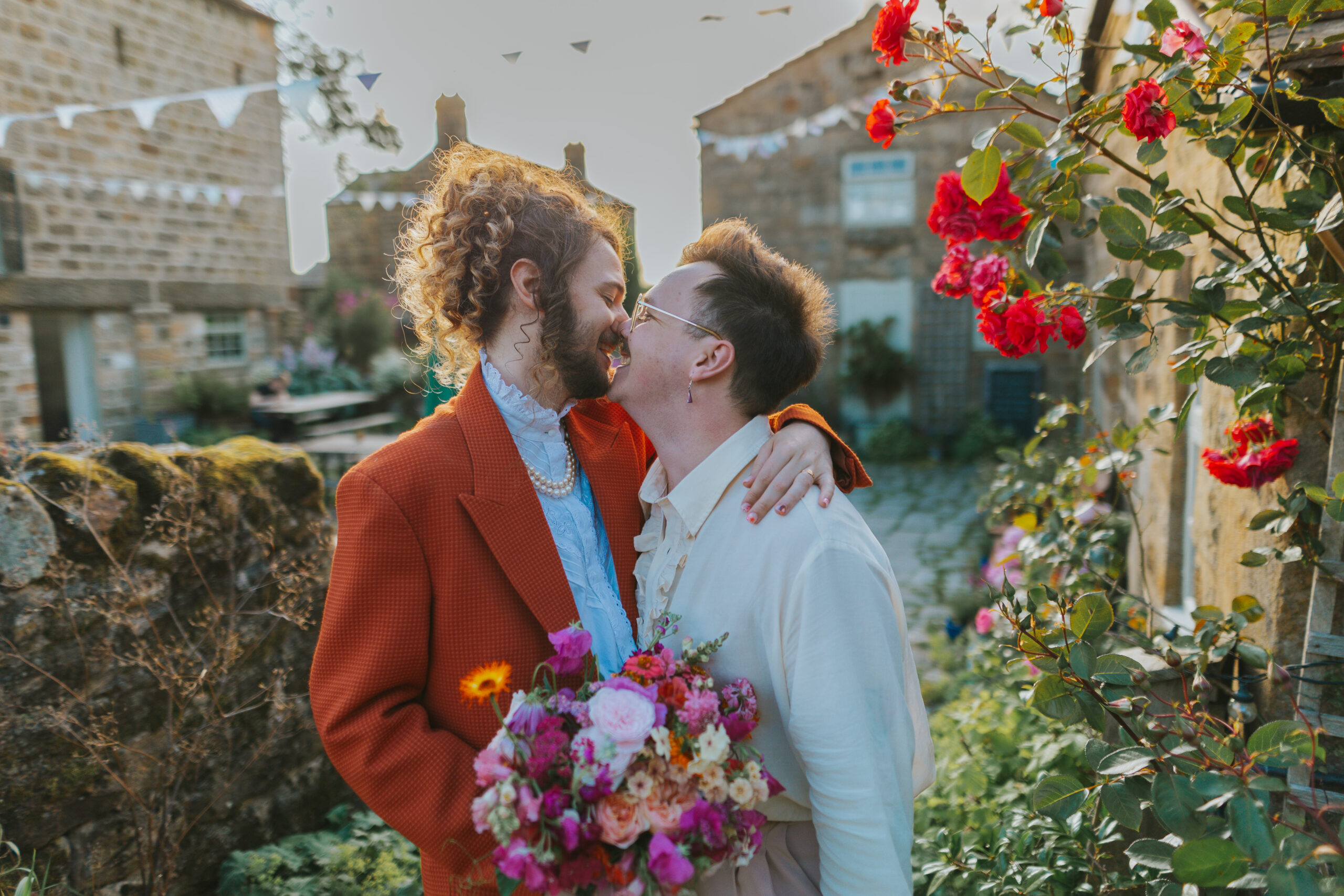 Couple at The Chilli Barn on their wedding day with a colourful bouquet by Leafy Couture Flowers. Photographed by Slate Cottage Studio - whom guided the couple to achieve relaxed wedding photography